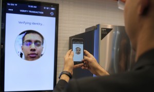 Raghav Malik, Senior Analyst in Enterprise Security Solutions doing a product demonstration of Identity Check in MasterCard stand at the Mobile World Congress in Barcelona, Spain, Monday, Feb. 22, 2016. The company displayed the future of payments for devices and wearables. (Carlos Alonso/AP Images for MasterCard)